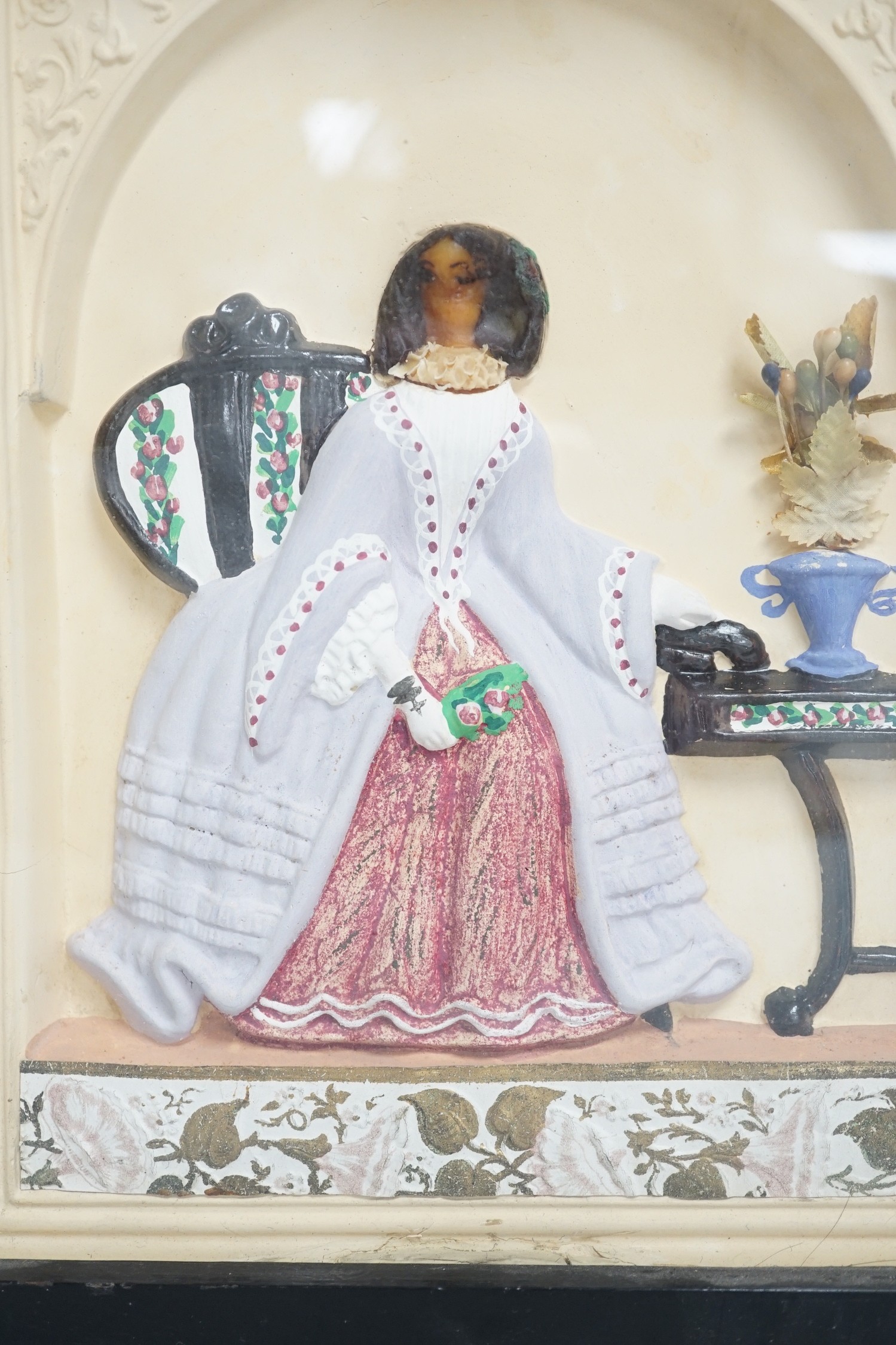 A pair of painted wax relief plaques, framed